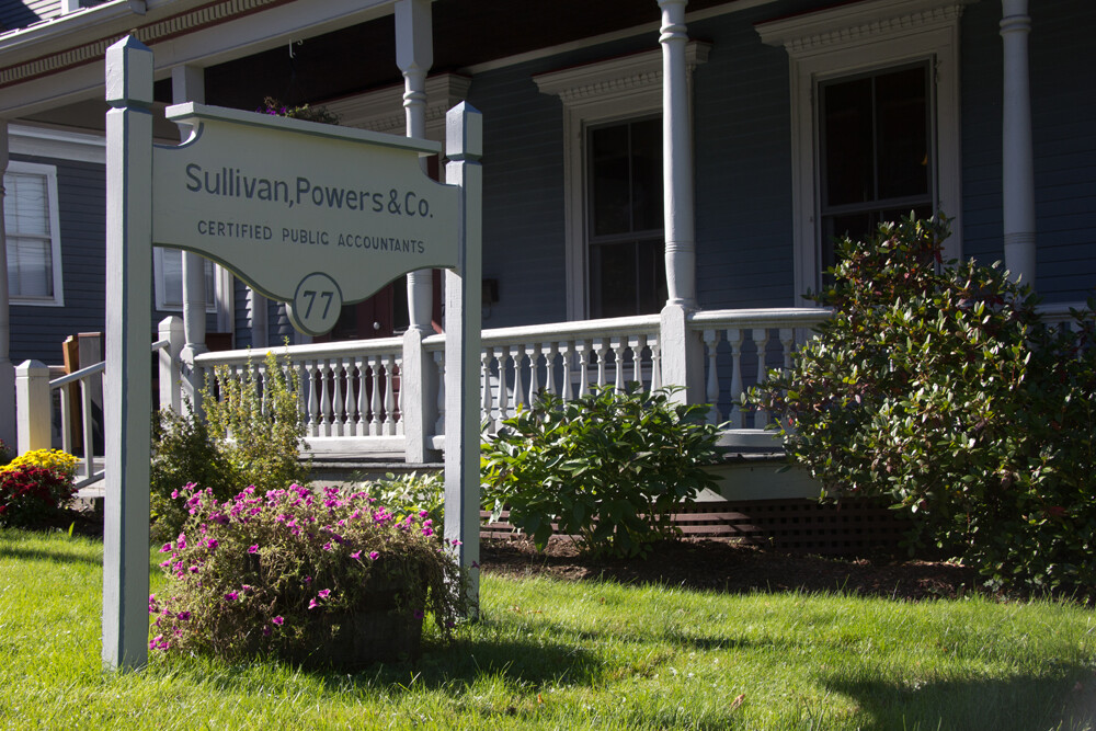 Sign for Sullivan, Powers & Co., Certified Public Accountants, outside a house.